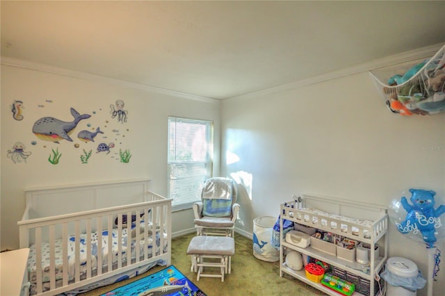 bedroom with carpet floors, a nursery area, and crown molding