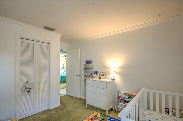 carpeted bedroom with a crib, a closet, and ornamental molding