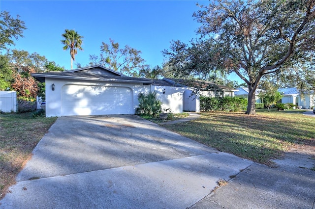 view of front of property featuring a garage and a front lawn