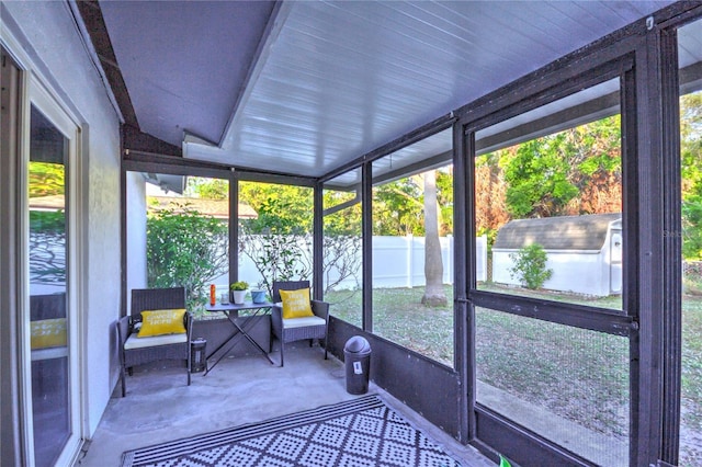 unfurnished sunroom featuring vaulted ceiling