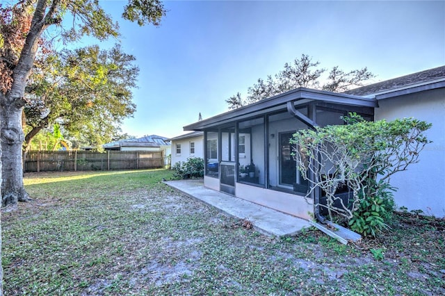 view of yard featuring a sunroom