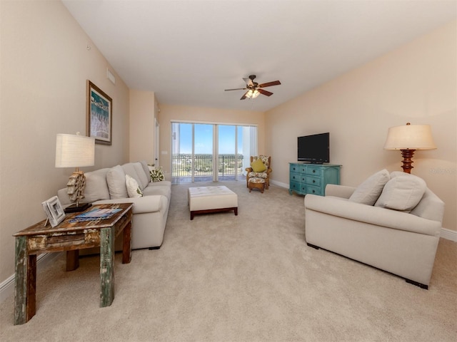 living room featuring light carpet and ceiling fan