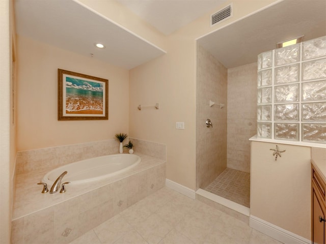 bathroom featuring tile patterned floors, plus walk in shower, and vanity