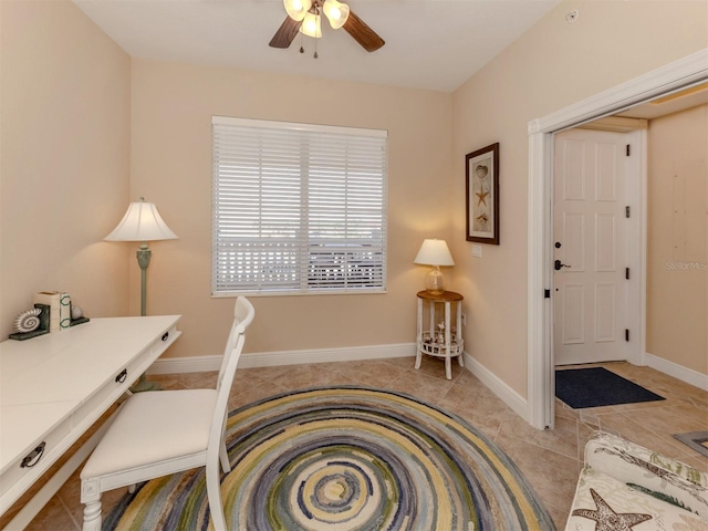 office area with light tile patterned floors and ceiling fan