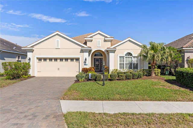 view of front of house with a garage and a front yard