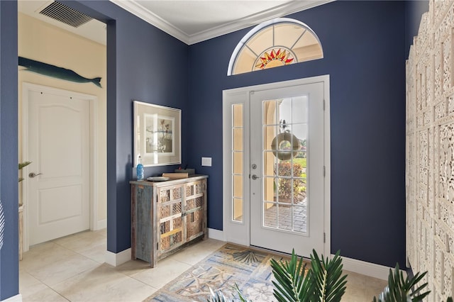 foyer entrance with light tile patterned floors and ornamental molding