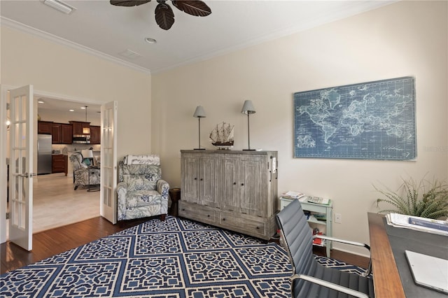 living area with ceiling fan, dark hardwood / wood-style floors, and ornamental molding