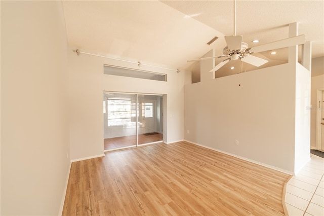 spare room featuring ceiling fan, lofted ceiling, and light hardwood / wood-style flooring