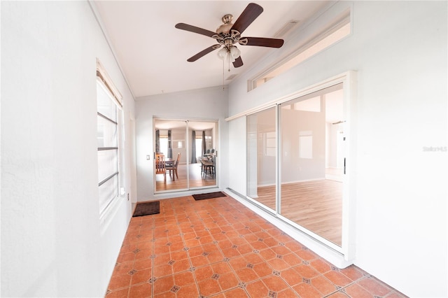 unfurnished sunroom with ceiling fan and lofted ceiling