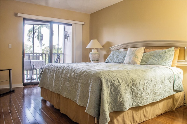 bedroom with access to exterior and dark wood-type flooring