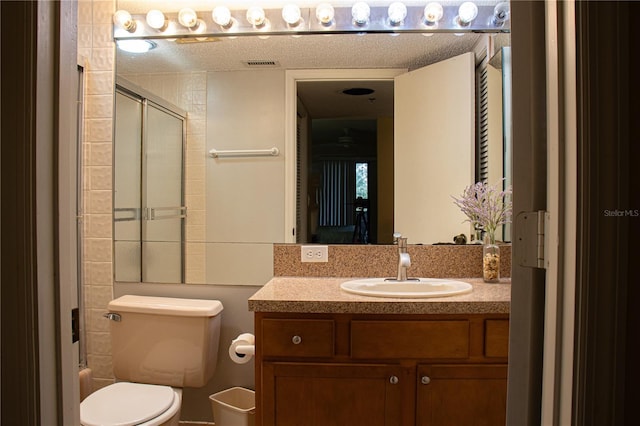 bathroom with vanity, a textured ceiling, and toilet