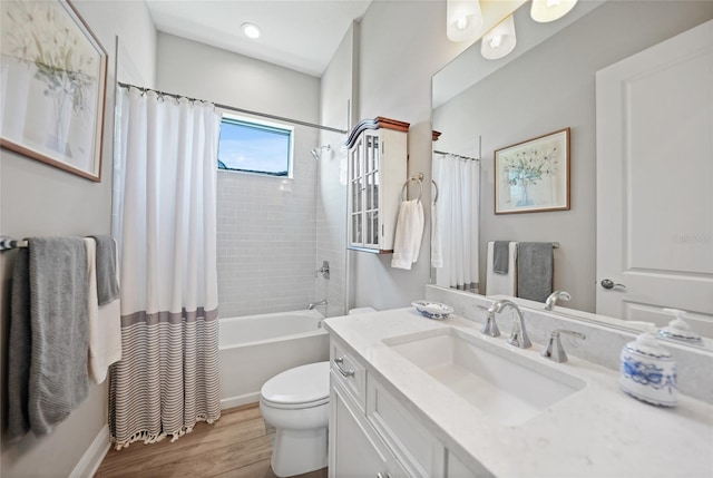 bathroom featuring toilet, wood finished floors, vanity, and shower / bathtub combination with curtain