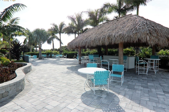 view of property's community with an outdoor bar and a patio