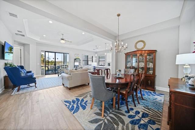 dining space featuring recessed lighting, a raised ceiling, visible vents, light wood-style floors, and baseboards