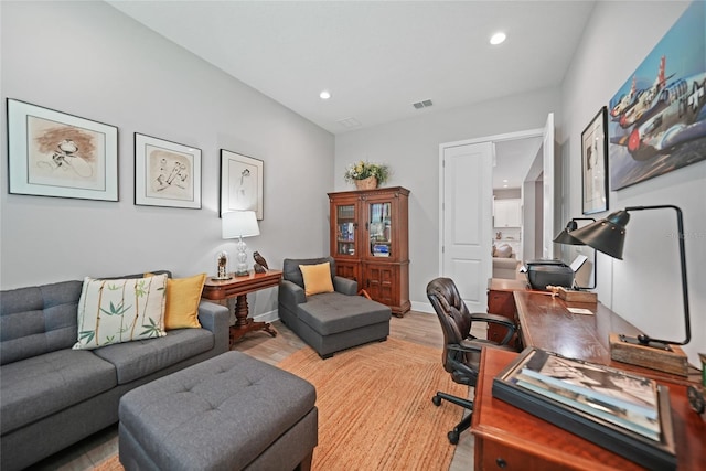 home office with recessed lighting, visible vents, light wood-style flooring, and baseboards