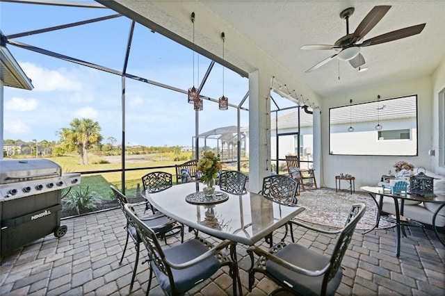 sunroom / solarium featuring ceiling fan and a wealth of natural light