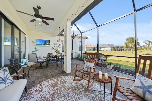 sunroom featuring a ceiling fan