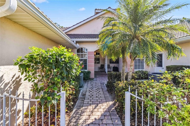 property entrance with a patio and central AC unit