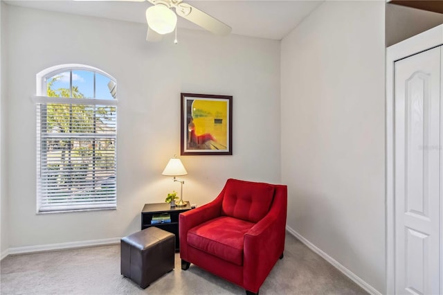 sitting room with light colored carpet and ceiling fan