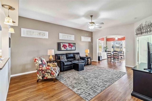 living room with hardwood / wood-style floors and ceiling fan