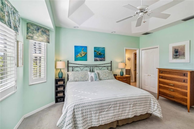 bedroom with light carpet, a closet, and ceiling fan