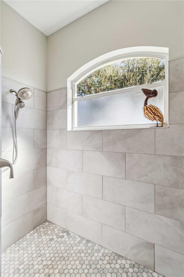 bathroom with tiled shower