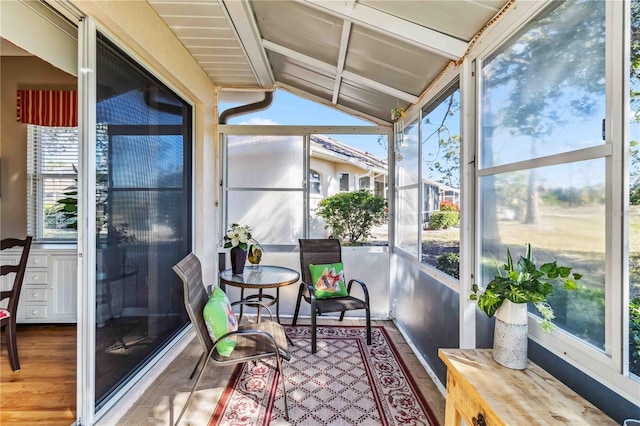 sunroom / solarium with lofted ceiling with beams