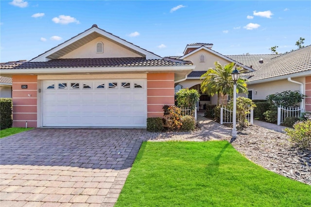 view of front of property with a front lawn and a garage