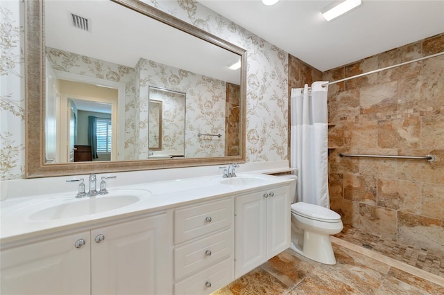 bathroom featuring curtained shower, vanity, and toilet