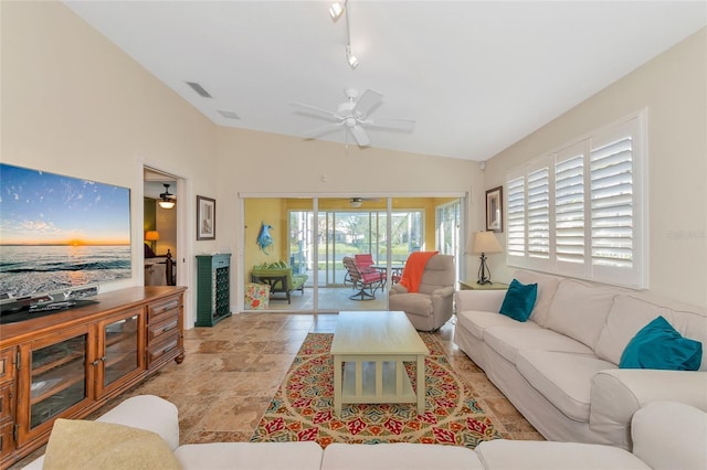 living room featuring ceiling fan and lofted ceiling