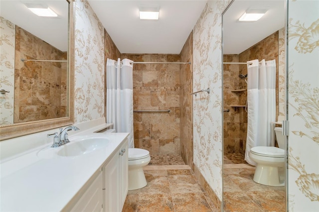 bathroom with vanity, curtained shower, and toilet