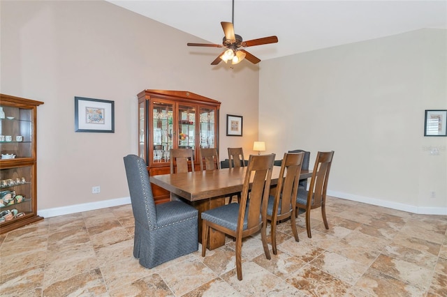 dining space featuring high vaulted ceiling and ceiling fan