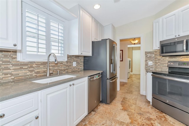 kitchen featuring white cabinetry, sink, and appliances with stainless steel finishes