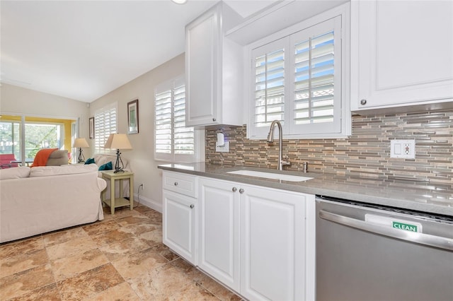 kitchen with dishwasher, white cabinetry, plenty of natural light, and sink