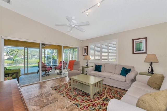 living room featuring plenty of natural light, ceiling fan, and vaulted ceiling