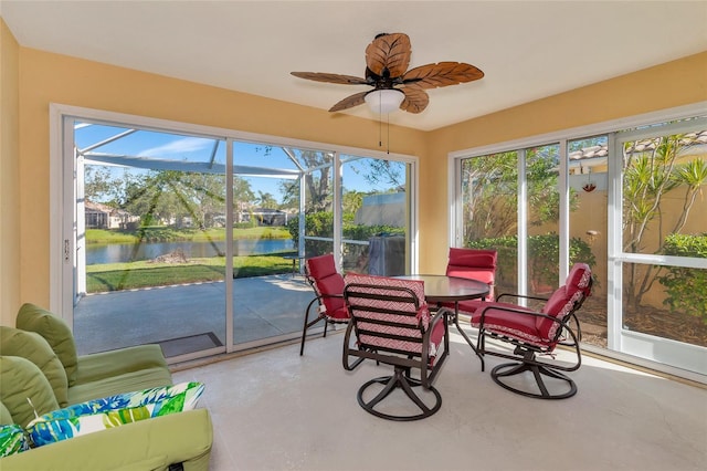 sunroom / solarium featuring a wealth of natural light, a water view, and ceiling fan