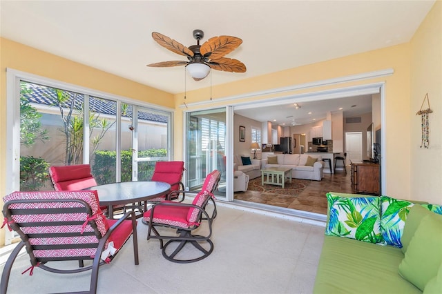 sunroom featuring ceiling fan