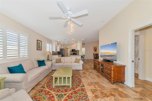 living room featuring ceiling fan and lofted ceiling