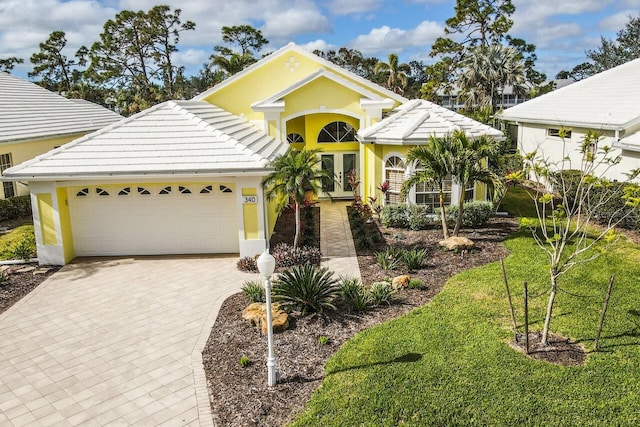 view of front of house with a garage and a front yard