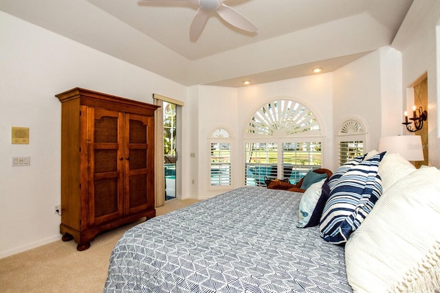 bedroom with access to outside, light colored carpet, and ceiling fan