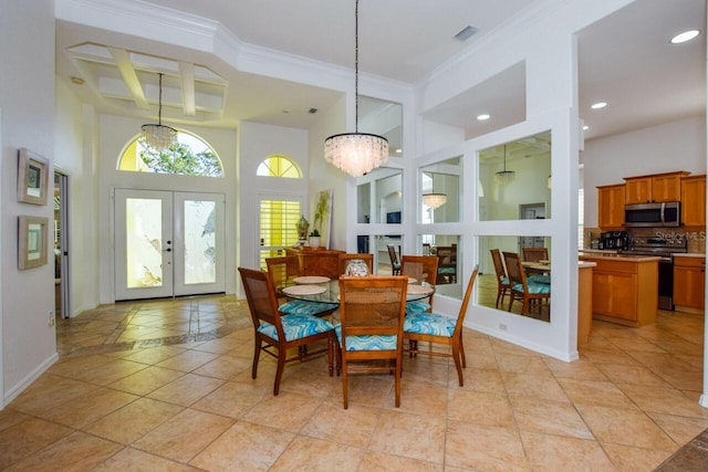 tiled dining area with french doors, coffered ceiling, an inviting chandelier, and a high ceiling