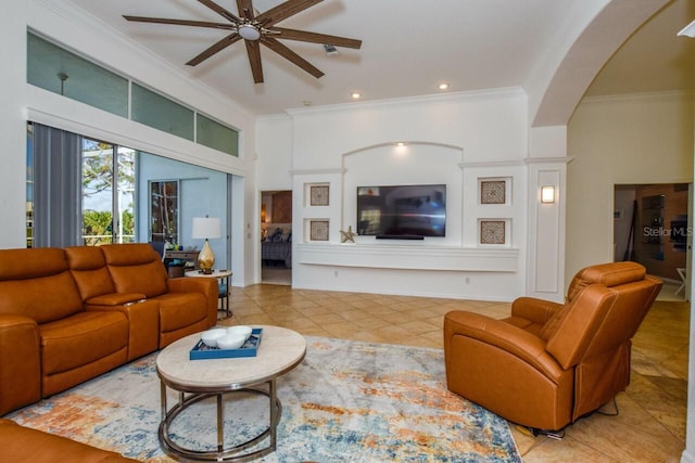 living room featuring light tile patterned floors, crown molding, and ceiling fan