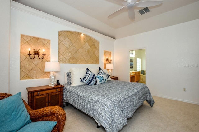 bedroom featuring ceiling fan, ensuite bath, and light carpet