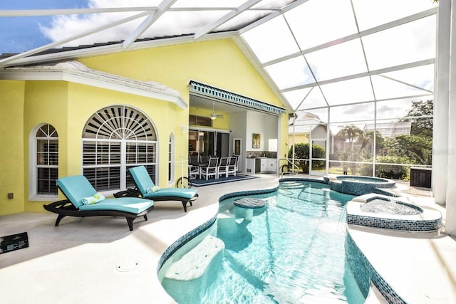 view of pool featuring a lanai, a patio, and an in ground hot tub