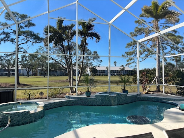 view of pool with a lanai and an in ground hot tub