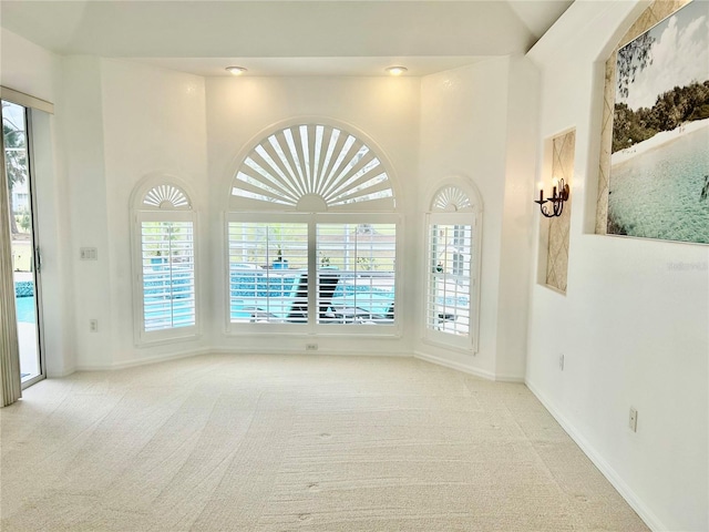 empty room featuring light carpet and a wealth of natural light