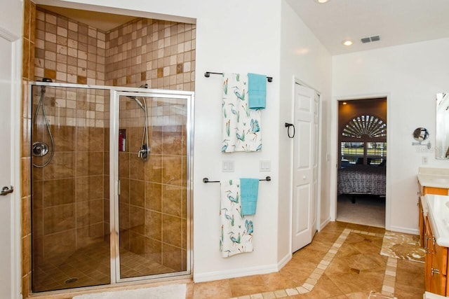 bathroom featuring vanity and a shower with door