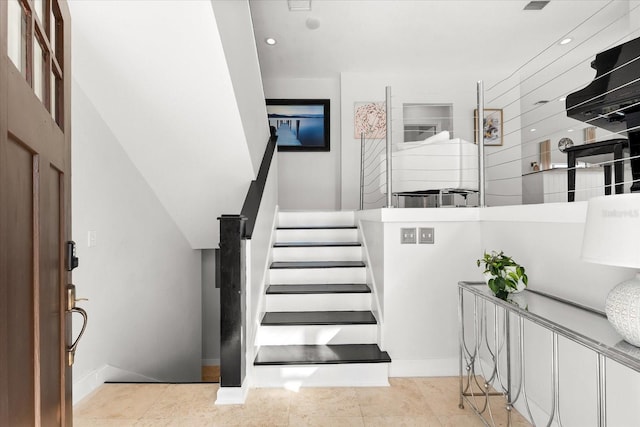 stairway featuring tile patterned flooring