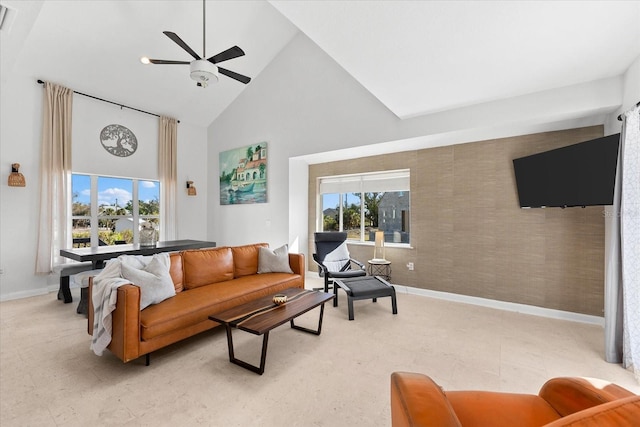 living room with ceiling fan and high vaulted ceiling