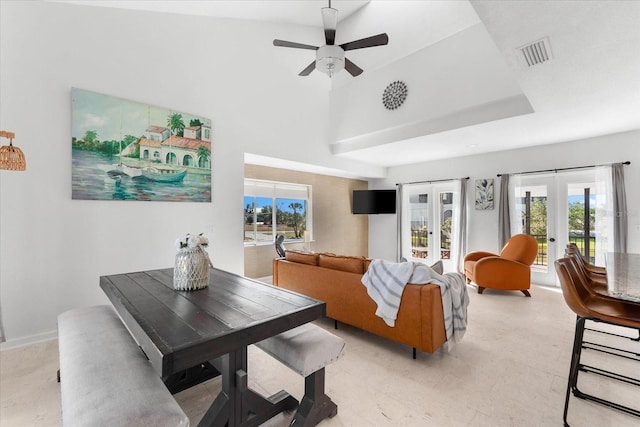 living room featuring ceiling fan, a high ceiling, and french doors